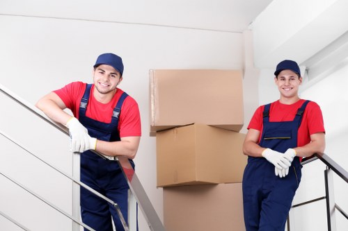 Movers carrying furniture from a flat in Neasden with careful handling
