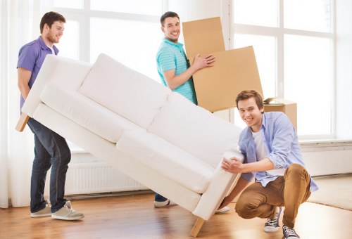 Furniture collection team handling bulky items in a Neasden home