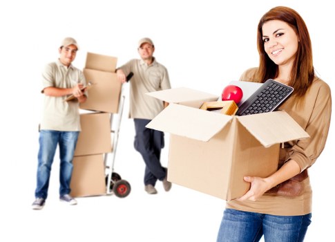 Professional office movers handling desks and equipment