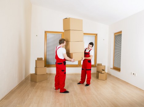 Local office relocation team handling furniture and filing boxes in Neasden